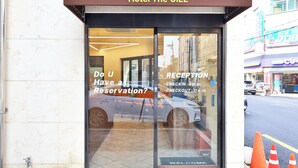 Hotel The CIEL with a reception area, a car parked outside, and a 'Do you have a reservation?' sign.