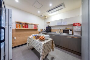 A kitchenette with a microwave, coffee maker, and a refrigerator. - The Ciel Hotel (Gyeongju)