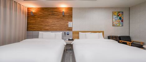 A hotel room with two beds, a wooden accent wall, a painting, and a desk with a chair.