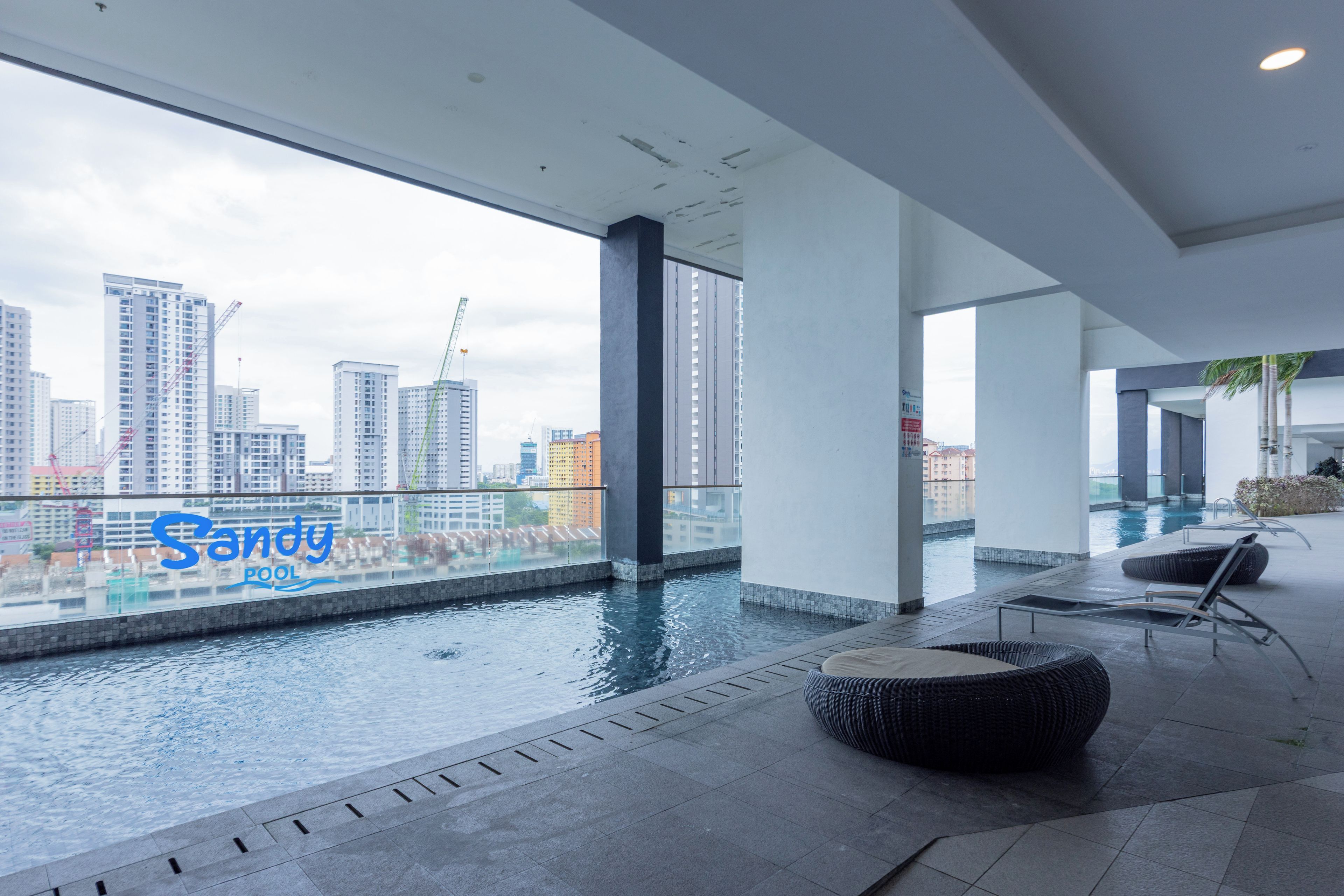A modern indoor pool area with a view of the city skyline.