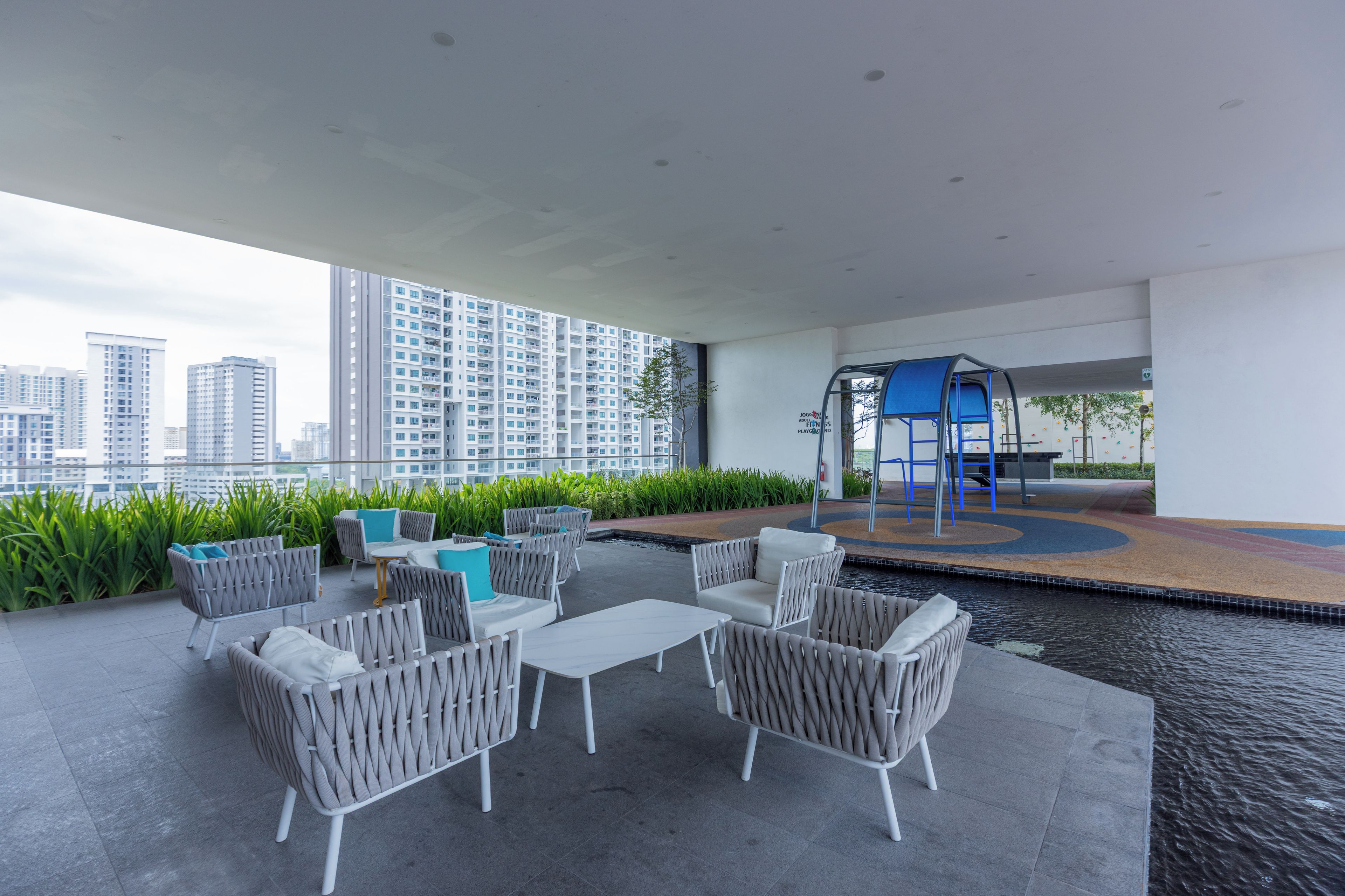 A rooftop terrace with outdoor seating, a small pool, and a playground area.