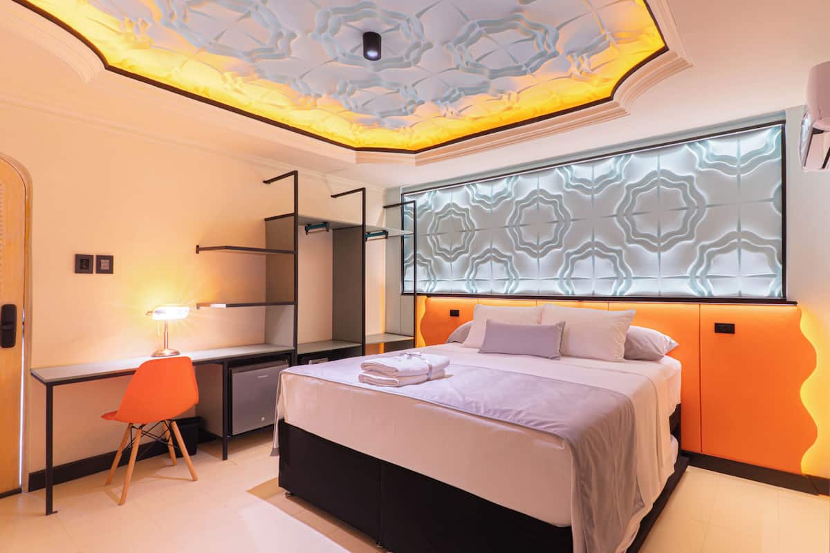 Une chambre à coucher moderne avec un lit, un bureau et une chaise.