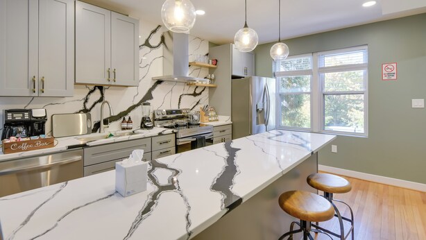 A modern kitchen with marble countertops, stainless steel appliances, and pendant lighting. - 8 Mi to DC: Cheverly Apt w/ Easy Metro Access (Cheverly)