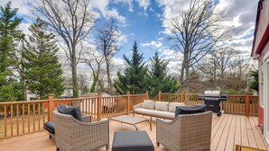 A wooden deck with wicker furniture, a barbecue grill, and a view of trees and sky. - 8 Mi to DC: Cheverly Apt w/ Easy Metro Access (Cheverly)