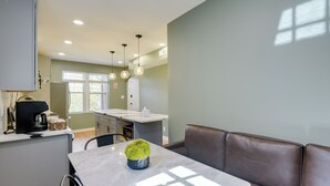 A modern kitchen with a dining area, including a marble table and a brown leather couch. - 8 Mi to DC: Cheverly Apt w/ Easy Metro Access (Cheverly)