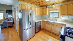 A kitchen with wooden cabinets, stainless steel appliances, and a wooden floor. - Scenic Getaway, 10 Mi to Snowshoe Mountain & Lake! (Snowshoe)