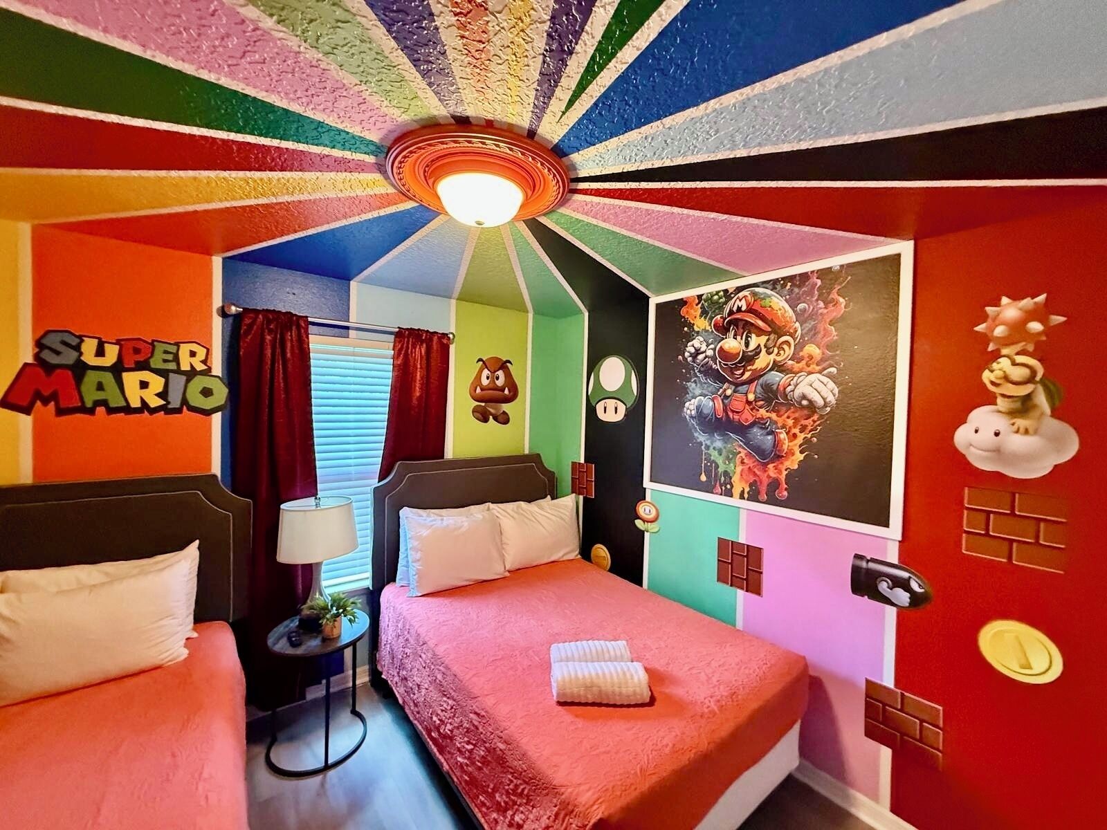 A Super Mario themed room with a bed, two nightstands, a ceiling fan, and wall decorations including a Mario poster and Toad character.