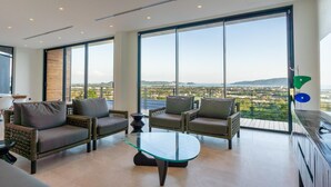 A spacious living room with large windows, a glass coffee table, and comfortable seating. - Stunning Views -  Villa Maan Ingfah VMI1 (Chalong)