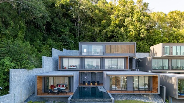 A modern multi-story house with a swimming pool, large windows, and a stone exterior. - Stunning Views -  Villa Maan Ingfah VMI1 (Chalong)