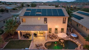 A residential house with a backyard patio, a swimming pool, and solar panels on the roof. - Chill & Thrill | Pool, Hot Tub • Family Game Villa (Casa Grande)