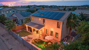 A two-story house with a swimming pool, solar panels, and a covered patio area. - Chill & Thrill | Pool, Hot Tub • Family Game Villa (Casa Grande)