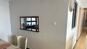A modern kitchen with a built-in stove, a window, and a dining area with a table and chairs. - Spacious 5-bedroom apartment in terrific Nairobi -White Oak Residency with AC, (Nairobi)