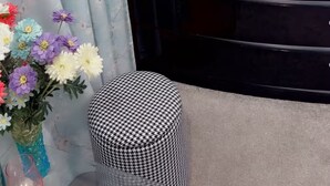 A room with a black vanity, a round mirror, a small stool, and a television on the wall. - “Private Bedroom & Large Deck + Separate Entrance” (Papatoetoe)
