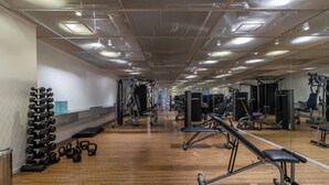 A gym with various exercise equipment, wooden flooring, and mirrored walls. - Frei215 in S o Paulo (São Paulo)