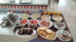 A breakfast buffet with various food items and beverages. - Three Brothers Hotel (Aegina)