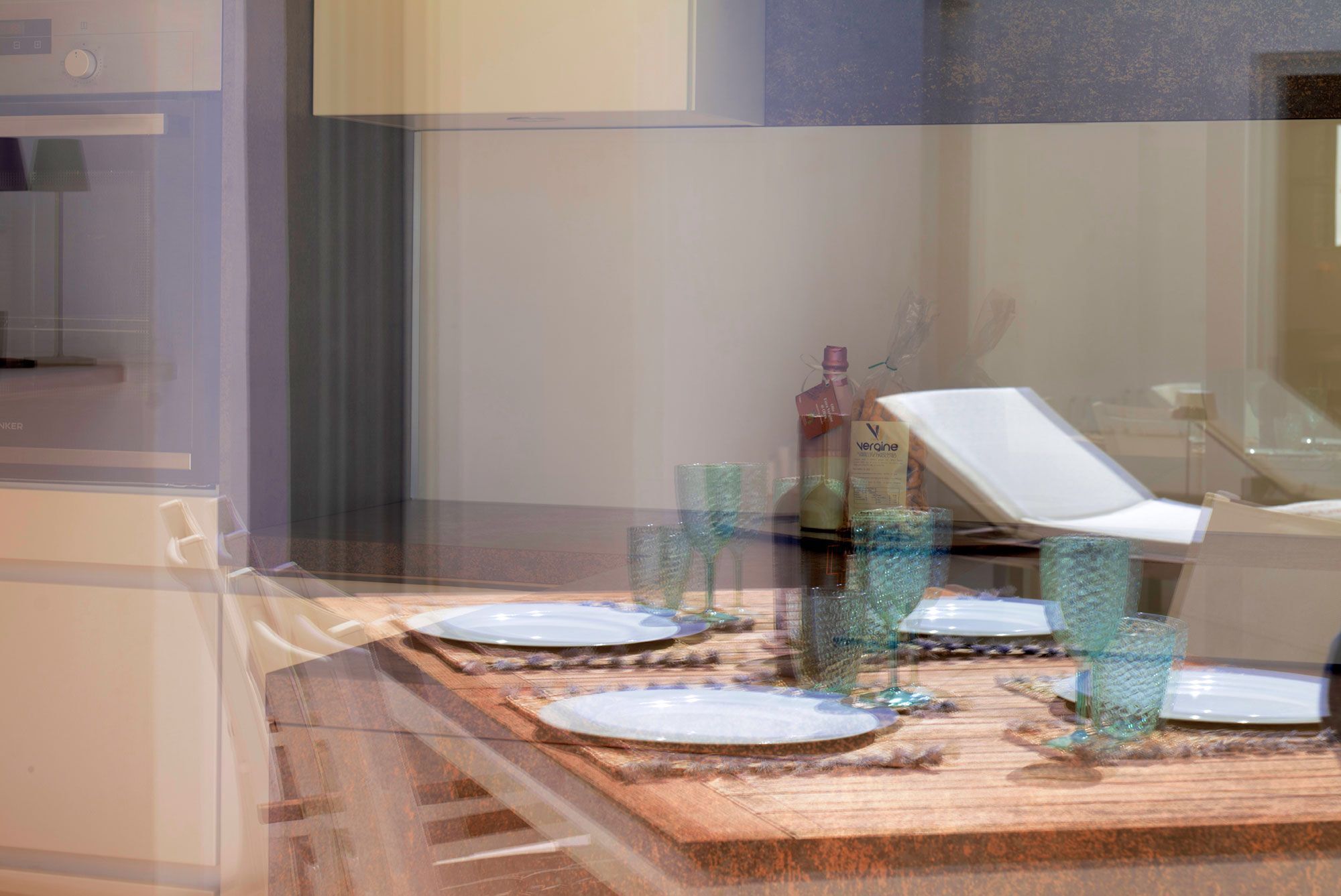 A dining area with a wooden table set for four, surrounded by glassware and plates.