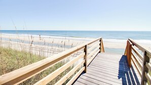 A wooden boardwalk leading to a beach with clear skies. - New Oceanfront Home | Private Beach Access (Topsail Beach)