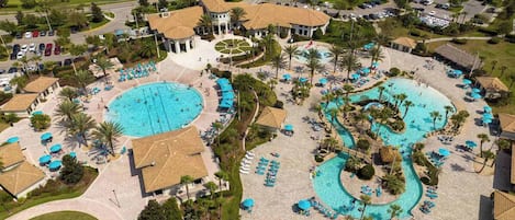 A resort with multiple swimming pools, sun loungers, and palm trees.
