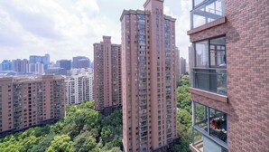 A high-rise residential building with multiple floors, large windows, and a brick facade. - Tyms Luxury 3BR 2BA APT Riverside (Shanghai)