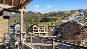 A resort with multiple buildings, a covered outdoor area with seating, and a view of a mountainous landscape. - Luxury Mountain Retreat - Private Hot Tub and Walk to Lifts (Keystone)