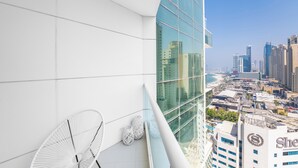 A modern building with a glass facade overlooking a cityscape. - Al Bateen I Ultra Luxury I Private Beach (Dubai)