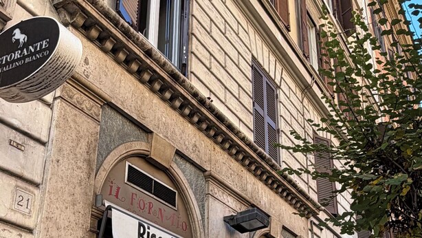 Un edificio con escaparates, incluyendo una pastelería y una panadería.