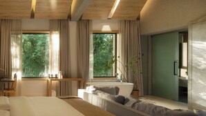 A modern bedroom with a large bed, a sitting area with a sofa and a coffee table, a desk, and a view of greenery through the windows. - Wangshanlife Snow Garden Design Hotel (Huangshan)