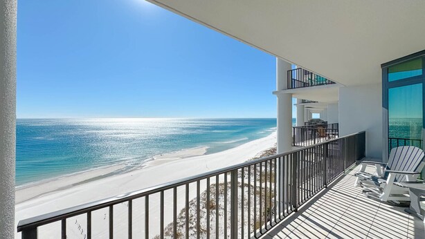 A balcony with a view of a beach and ocean. - Beachfront 3BR, Lazy River/Slide, On-site Cafe and Bar! (Orange Beach)