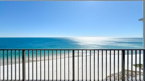 A balcony with a view of a beach and ocean. - Beachfront 3BR, Lazy River/Slide, On-site Cafe and Bar! (Orange Beach)