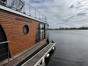 A boat with a wooden exterior, a metal railing, and a nameplate reading 'SEEFELDER.'