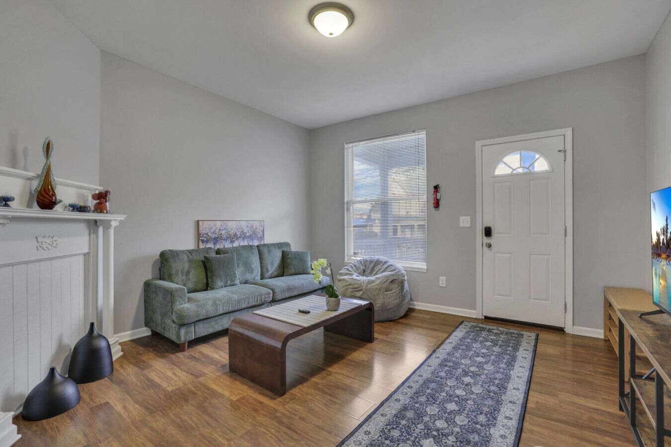 A living room with a sofa, coffee table, and a rug.