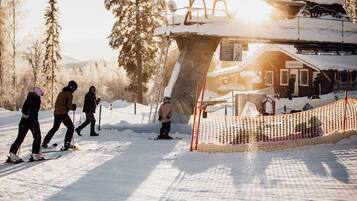 A ski resort with a chairlift, a building labeled 'VARMESTUGA', and a snow-covered landscape.