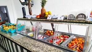 A buffet counter with various fruits and pastries. -  JHS Palace Hotel  (Boa Esperança)