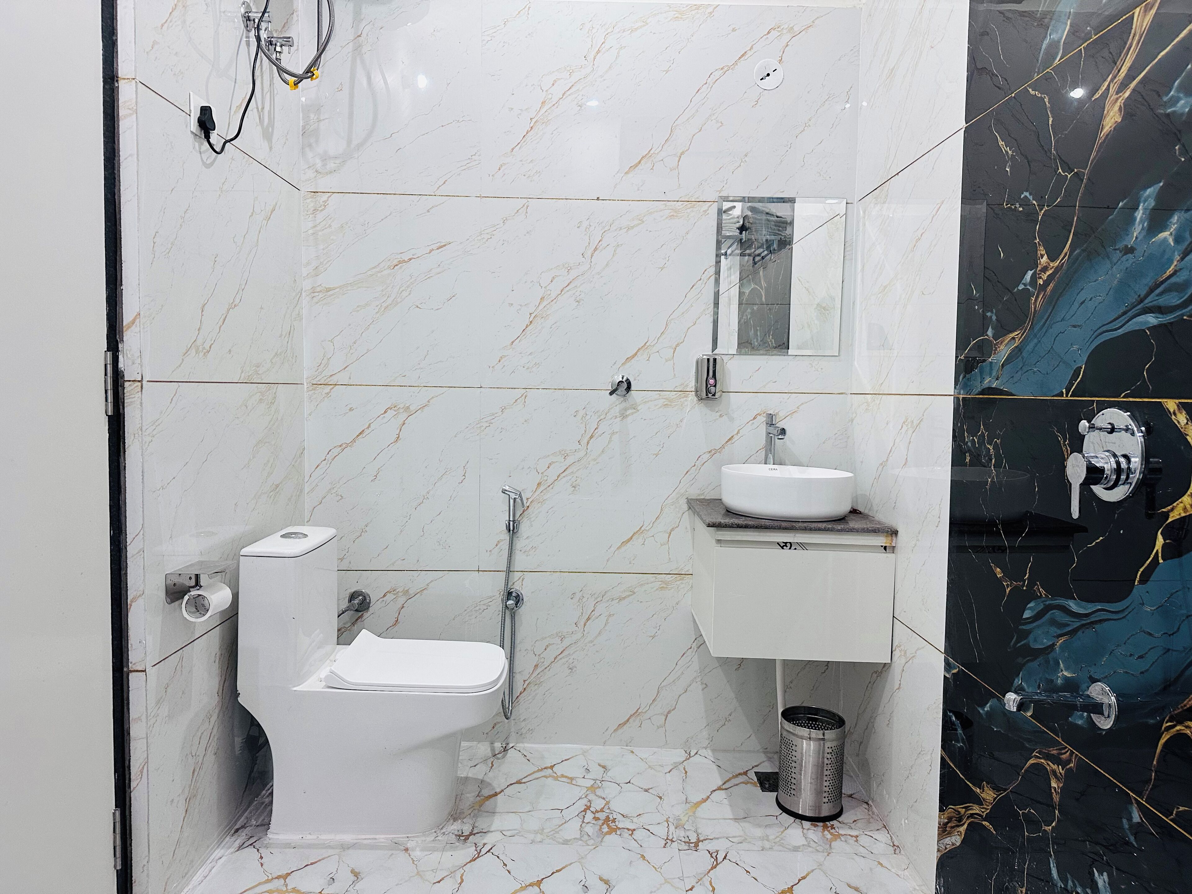 A bathroom with a toilet, sink, and shower.