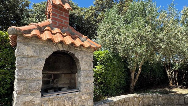 A stone-built outdoor kitchen with a tiled roof and an archway entrance. - Holiday apartment mit Klimaanlage und Terrasse (Krk)