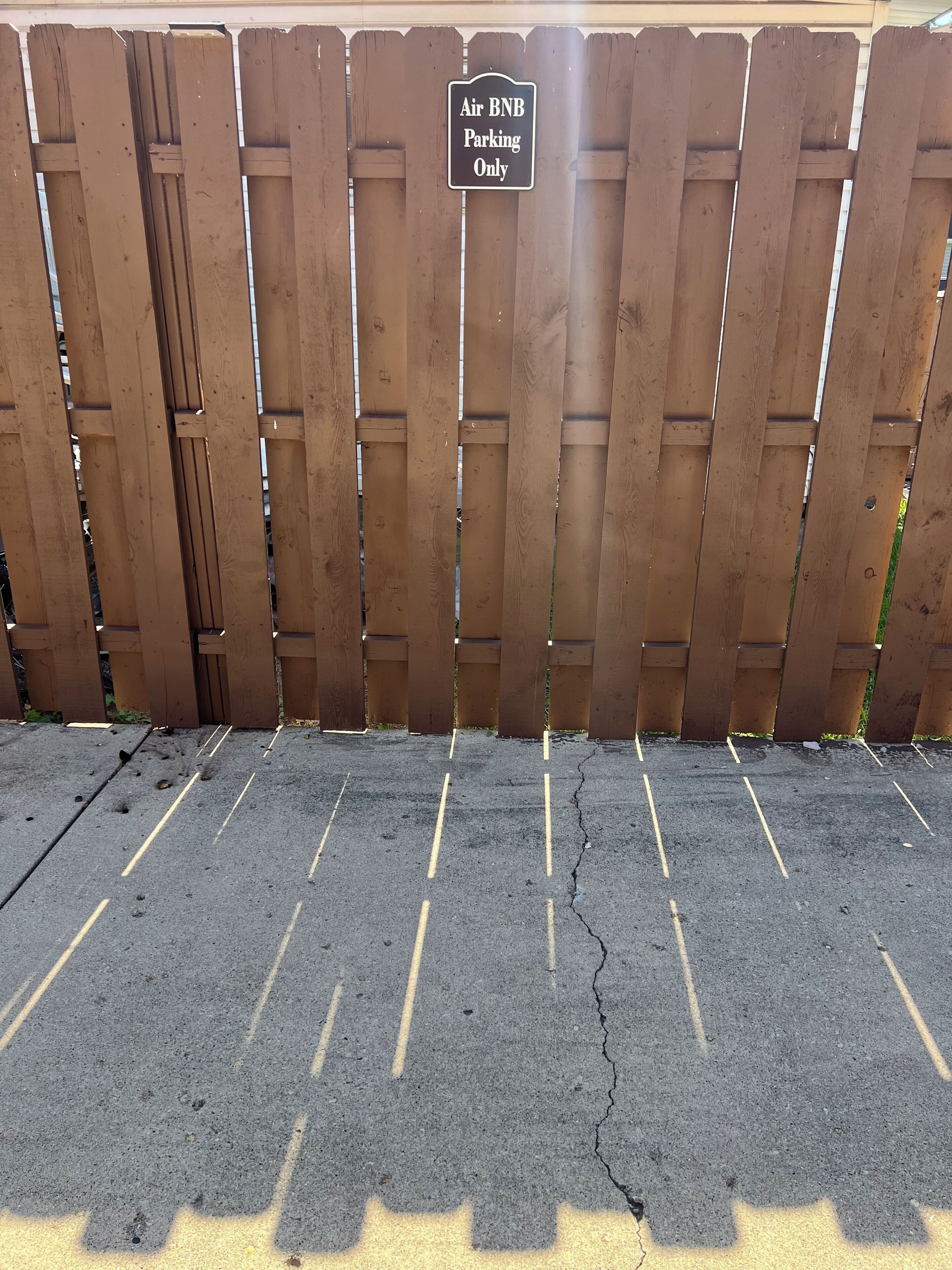 A wooden fence with a sign that reads 'Air BNB Parking Only.'
