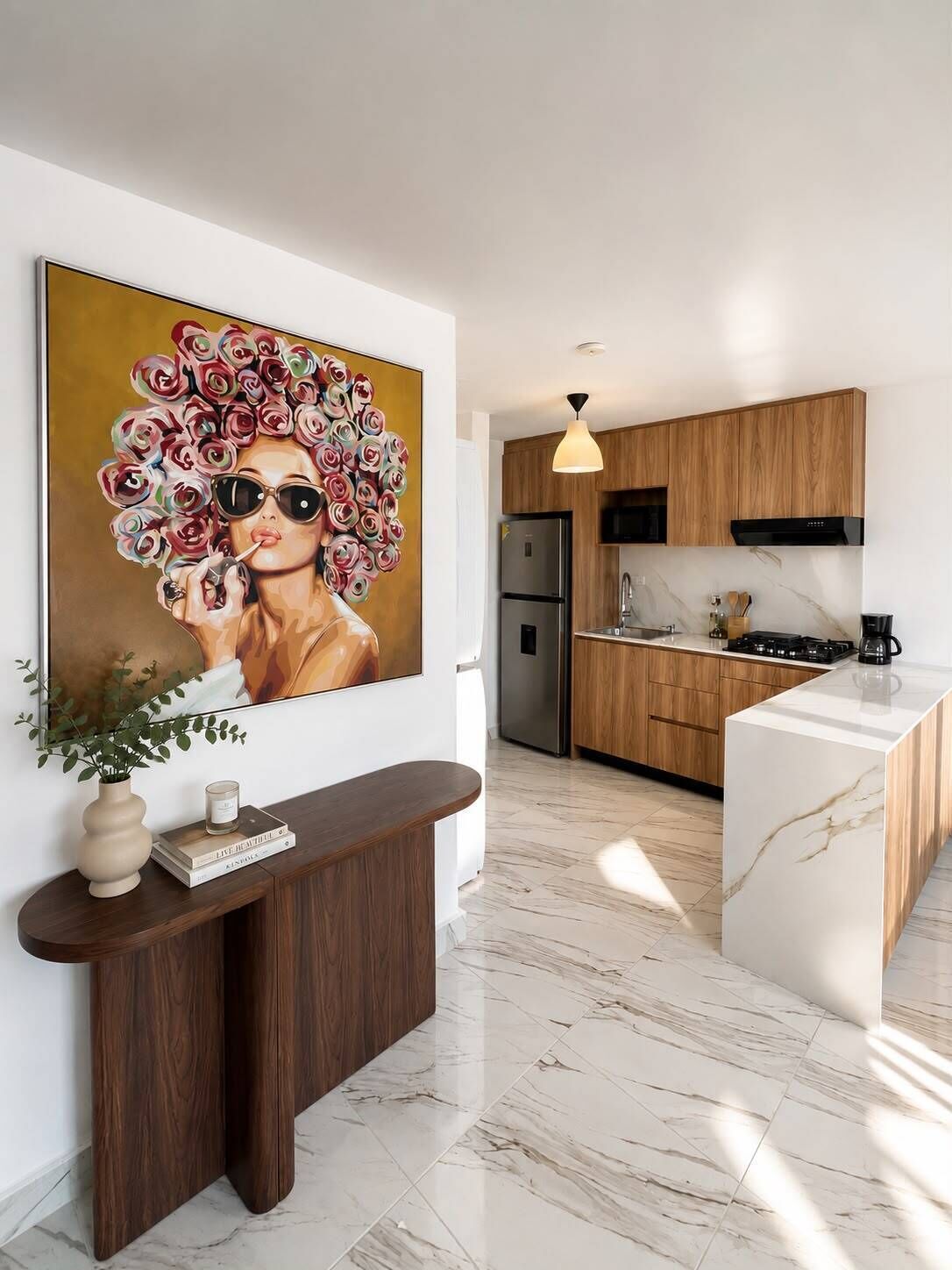 A modern kitchen with wooden cabinets, a marble countertop, and a stainless steel refrigerator.