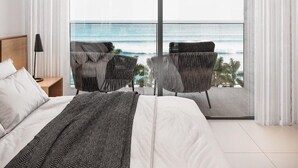 A bedroom with a large sliding glass door leading to a balcony with ocean views. - PORTO 2 LIFE RESORT - MARÉ ALTA (Ipojuca)