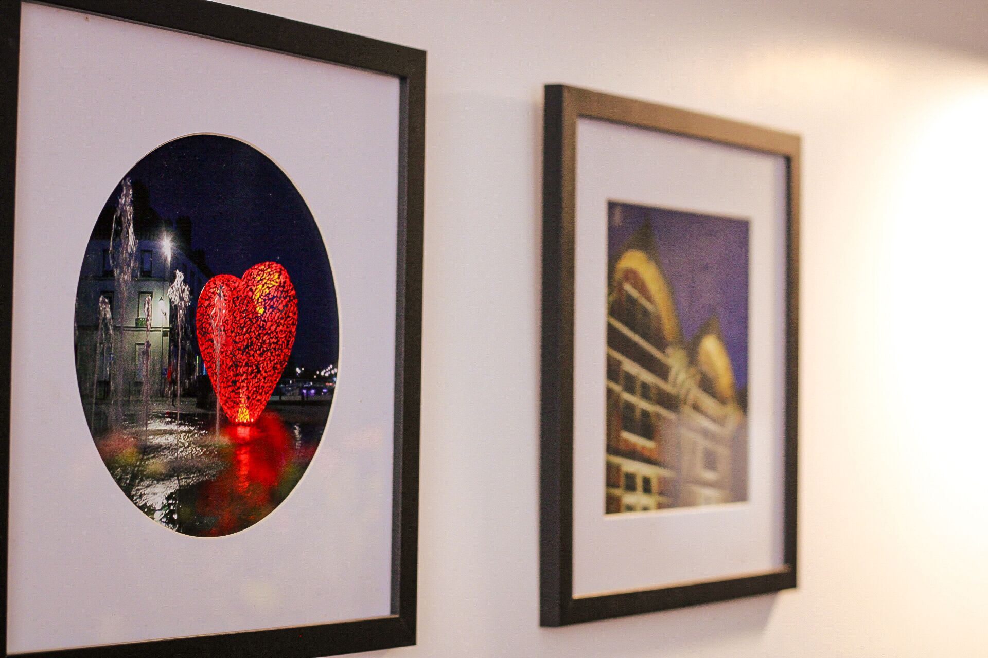 Two framed artworks on a wall.