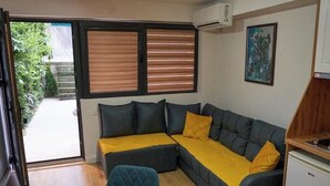 A compact living space with a sofa, a chair, and a small table.