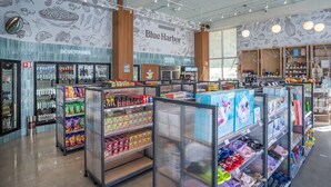 A Blue Harbor Market with refrigerated beverage sections, frozen goods, and dairy aisles.