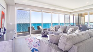 A spacious balcony with a view of the ocean, a grey sofa, and a glass table. - May The Force Be With You! The Galaxy Star Wars Theme at Encantame Towers C801 (Puerto Peñasco)