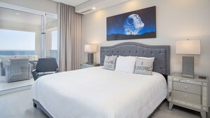 A modern hotel room with a large bed, two bedside tables, a nightstand, a balcony with wicker furniture, and a large window. - May The Force Be With You! The Galaxy Star Wars Theme at Encantame Towers C801 (Puerto Peñasco)