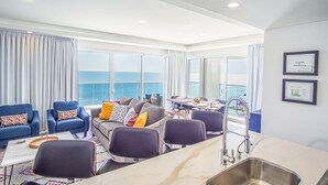 A modern room with a sofa set, dining table, and a kitchen area with a sink. - Beautiful 2 Bedroom Condominium Fully Equipped at the New Encantame Towers Verano 805 (Puerto Peñasco)