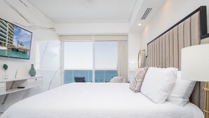 A hotel room with a large bed, a television on the wall, a view of the sea, and a balcony. - Stay in Luxury/splash in New Lazy River This Winter Encanatame Towers 903 (Puerto Peñasco)