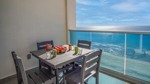 A balcony with a table set for two, featuring a view of the ocean. - Stay in Luxury/splash in New Lazy River This Winter Encanatame Towers 903 (Puerto Peñasco)