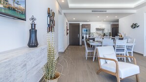 A modern living room with a dining area, a kitchen, and a view of a pool. - Beach Getaway 2 Bedroom Condo W802 (Puerto Peñasco)