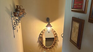 A staircase with a handrail, a wall-mounted mirror, and a light fixture. - Marciaga, rustic in ancient hamlet (Veneto)
