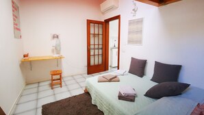 A bedroom with a bed, a desk, a chair, and a door. - THE ROOFTOP LOFT entire apartment in the center of Milan in Porta Venezia (Milano)