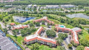 A resort with multiple buildings, swimming pools, and natural surroundings. - SeaWorld Orlando | 2BR | Minutes to the Parks (Orange County)